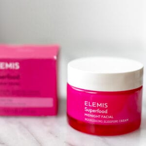 A jar of Elemis Midnight Facial and the box it comes in on a marble background.